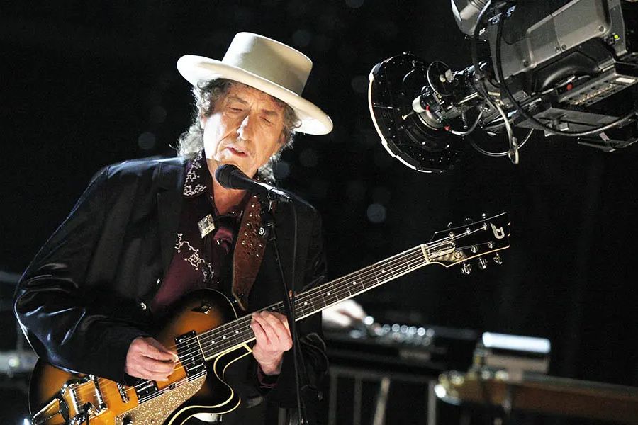 Which instrument did Bob Dylan famously play along with guitar?